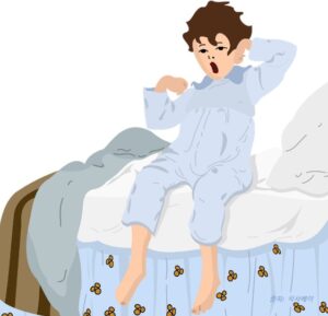 침대에서 하품하는 아이
