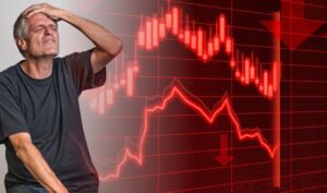 폭락하는 주식 그래프 앞에서 절망하는 남자