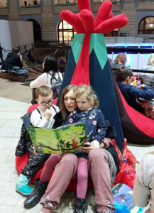 어머니가 아이들에게 책을 읽어주고 있다